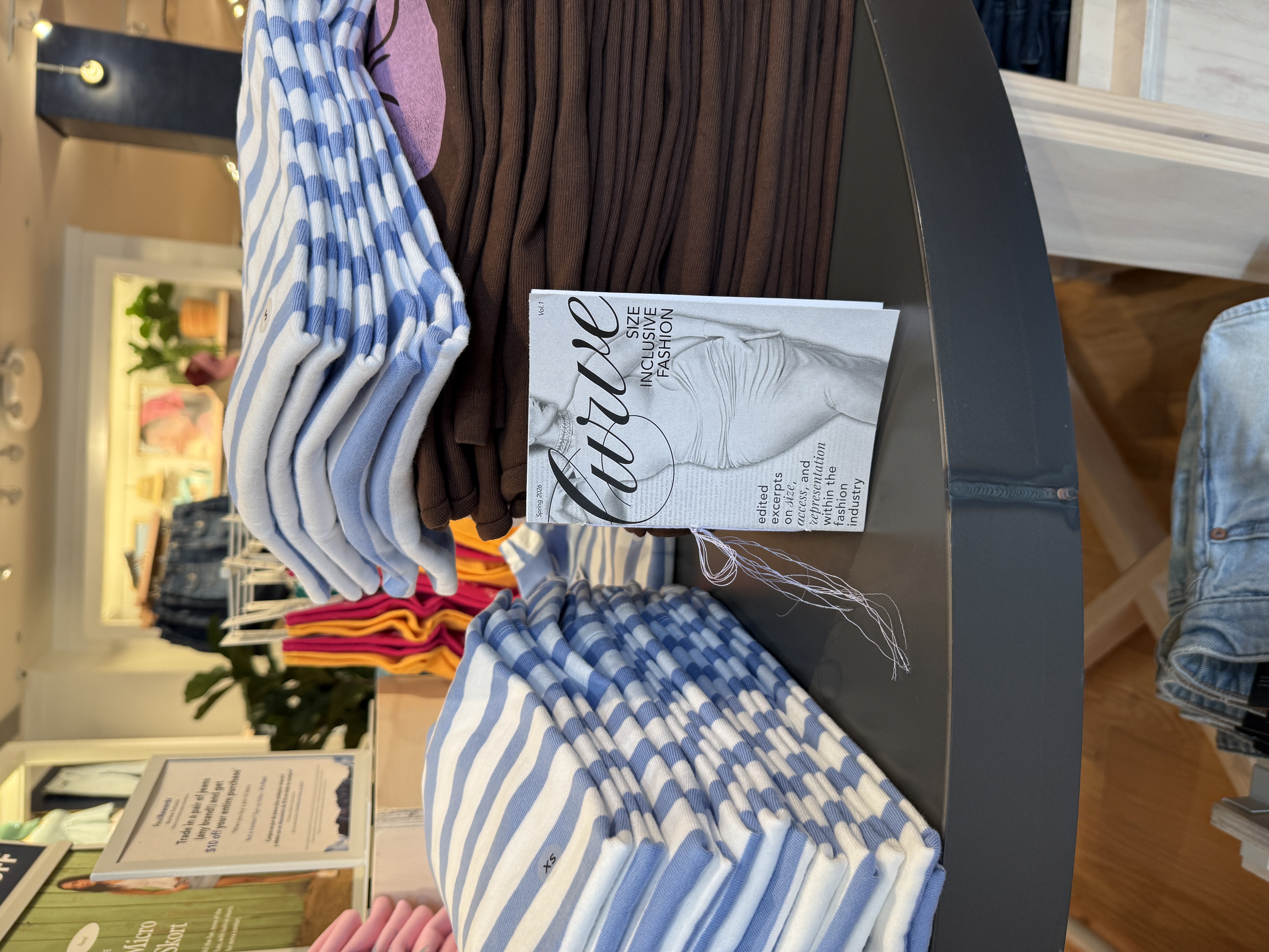 Zine on table of clothes in aerican eagle